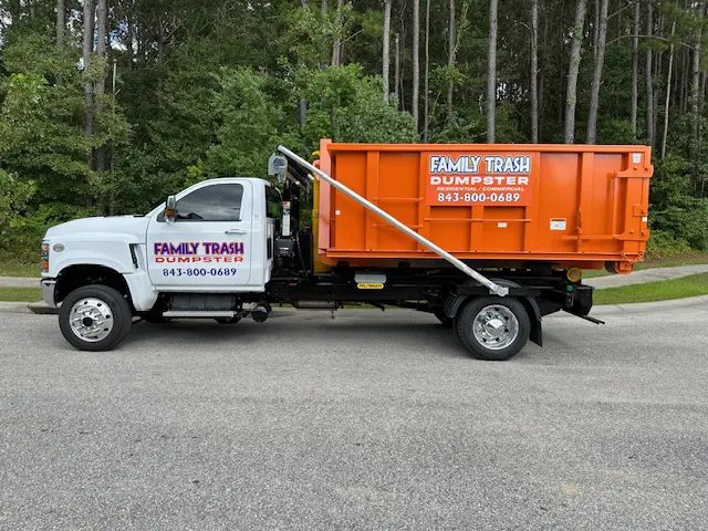 A Family Trash dumpster on a Charleston driveway
